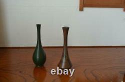 Furthermore A set of two bronze vases with a single flower