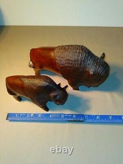 Set of two (2) carved wooden Ironwood buffalo adult and youth sculpture